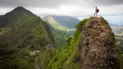 man on top of the mountain during daytime