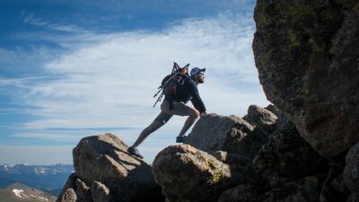 photo of man climbing mountain