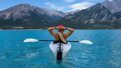 woman riding kayak at the middle of the sea