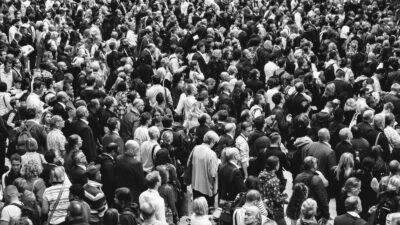 grascale photo of people standing on ground