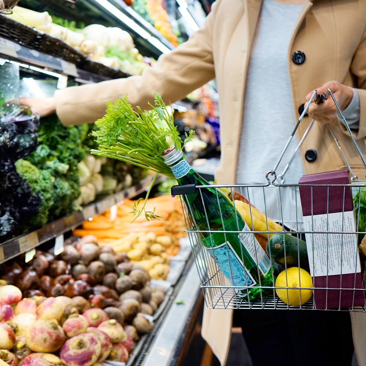 woman in white coat holding food and beverage