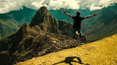 man jumping in green open field