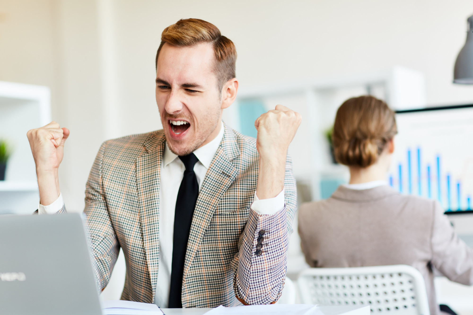 Channel Spiffs: Sales rep celebrating after receiving a reward.